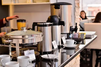 a counter with coffee pots and cups on it at Ankawa Hotel Boutique in Cusco