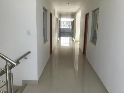 a long hallway with white walls and white floors at Antares Paracas in Paracas