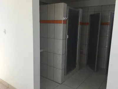 a bathroom with two stall doors and a shower at Antares Paracas in Paracas