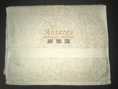 a white towel with the name of an alliance blankets hospital at Antares Paracas in Paracas
