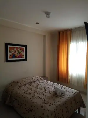 a bedroom with a bed and a window at Antares Paracas in Paracas