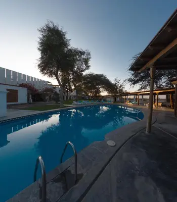 a large blue swimming pool in a building at Bodega el Huarango in Ica