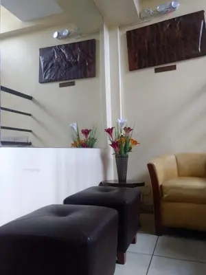 a waiting room with a couch and a chair at Hotel Sumaq Inn Sac in Lima