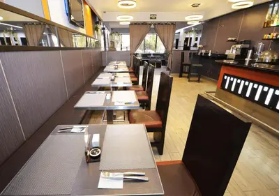 a long row of tables in a restaurant at qp Hotels Lima in Lima