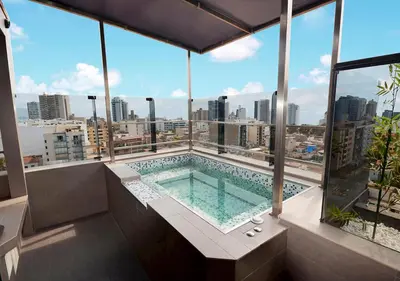 a swimming pool on the roof of a building at qp Hotels Lima in Lima