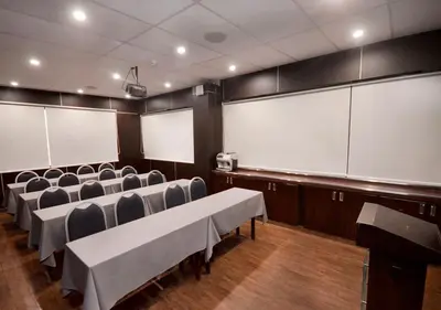 a conference room with rows of chairs and whiteboards at qp Hotels Lima in Lima