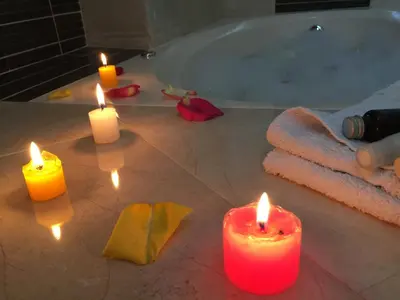 a group of candles in a bathroom with a tub at Suites El Parque in Lima