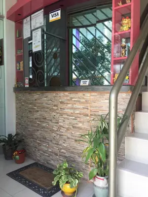 a lobby with stairs and plants in front of a building at Suites El Parque in Lima