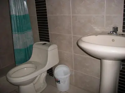 a bathroom with a toilet and a sink at Suites El Parque in Lima