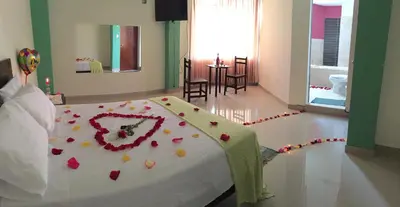 a bedroom with a bed with flowers on it at Suites El Parque in Lima