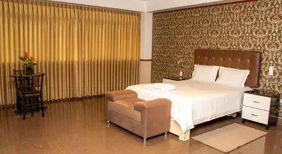 a bedroom with a bed and a chair in it at Hotel Costa Riviera in Mala