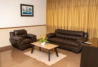 a living room with a couch and a coffee table at Hotel Costa Riviera in Mala