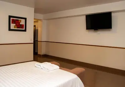 a room with a bed and a flat screen tv at Hotel Costa Riviera in Mala