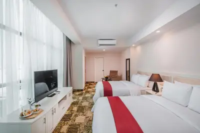 a hotel room with two beds and a flat screen tv at Nobility Grand Hotel in Lima