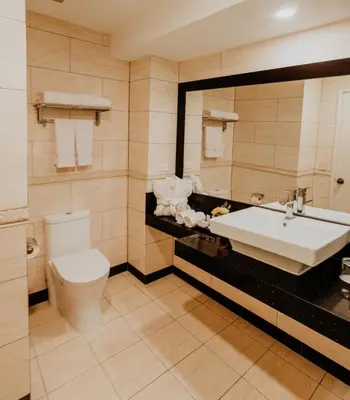 a bathroom with a sink and a toilet at Nobility Grand Hotel in Lima