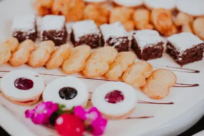 a plate of different types of desserts on a table at Nobility Grand Hotel in Lima