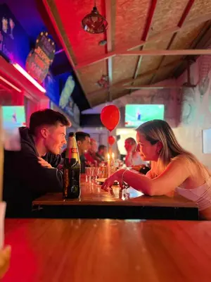 a man and a woman sitting at a bar at Pariwana Hostel Cusco in Cusco