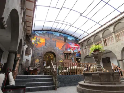 a building with stairs and a mural on the wall at Pariwana Hostel Cusco in Cusco