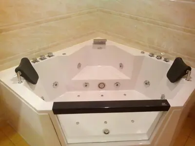 a white bath tub with a sink in a bathroom at Hotel Candamo in Lima