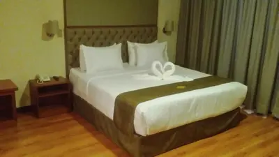 a bedroom with a large bed with a bow on it at Hotel Candamo in Lima