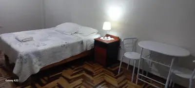 a small bedroom with a bed and two chairs at Lopez House in Lima