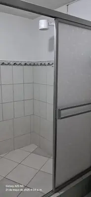 a shower with a glass door in a bathroom at Lopez House in Lima