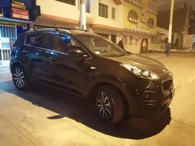 a small blue car parked on a city street at Lopez House in Lima