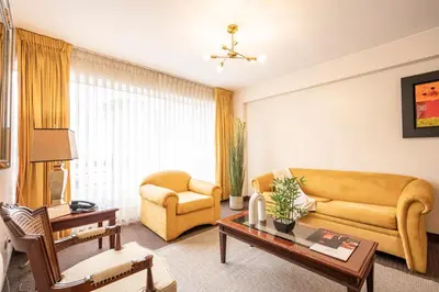 a living room with a couch and a table at Apart Hotel San Martin in Lima