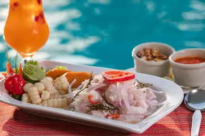 a plate of food with pasta and vegetables on a table at Hotel Chavín in Barranca