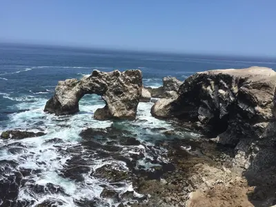 a group of rocks in the ocean near the water at Hotel Majoro in Nazca
