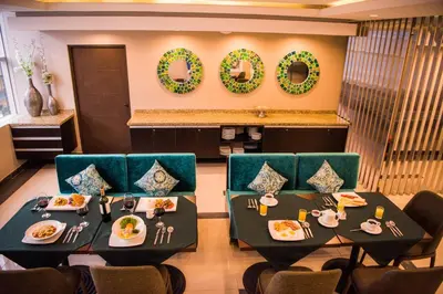 a dining room with two tables and chairs and wreaths at Hotel Diamond Lima in Lima