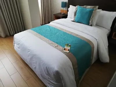 a hotel room with a large bed with a blue pillow at Hotel Diamond Lima in Lima