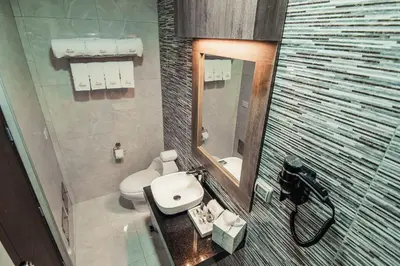 a bathroom with a white sink and a mirror at Hotel Diamond Lima in Lima