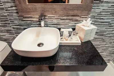 a bathroom with a white sink and a box of tissues at Hotel Diamond Lima in Lima