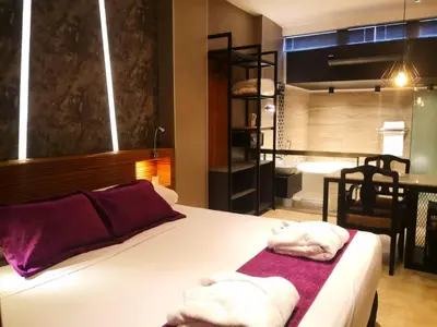 a bedroom with a bed with towels on it at Hotel Las Lomas in Lima