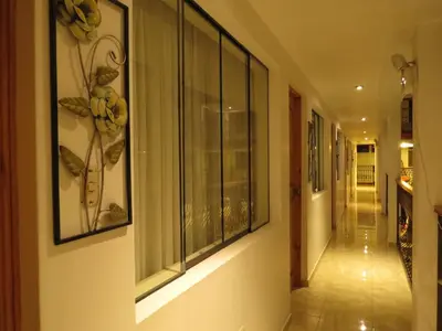 a hallway with some pictures on the wall at Hotel Las Flores in Ica