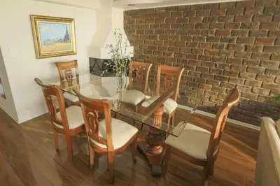 a dining room with a glass table and chairs at Oceanfront Penthouse in Miraflores in Lima