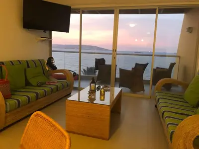 a living room with a couch and a view of the water at Paracas departamento Condominio Nautico in Paracas
