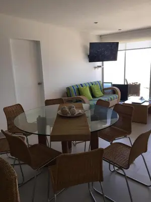 a living room with a glass table and a couch at Paracas departamento Condominio Nautico in Paracas