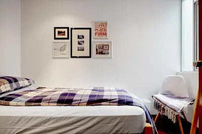 a bedroom with a bed and pictures on the wall at InkaHuset Pacasmayo in Lima