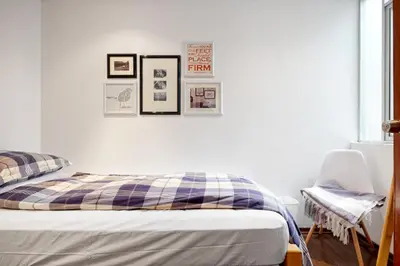 a bedroom with a bed and pictures on the wall at InkaHuset Pacasmayo in Lima