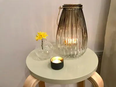 a table with a glass jar and a candle on it at InkaHuset Pacasmayo in Lima