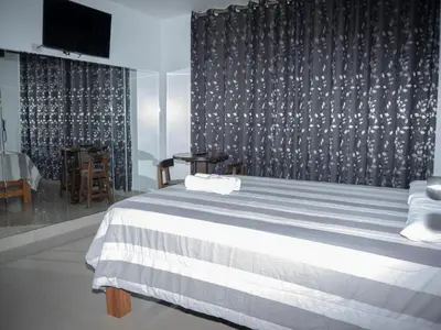 a bedroom with a bed with a black and white blanket at Hostal Sueños in Lima