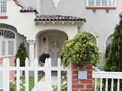 a white fence in front of a white house at Quinta Miraflores Boutique Hotel in Lima