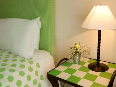 a bedroom with a bed and a table with a lamp at Quinta Miraflores Boutique Hotel in Lima