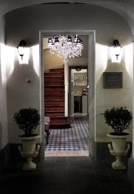 a hallway with a chandelier and two vases at Quinta Miraflores Boutique Hotel in Lima