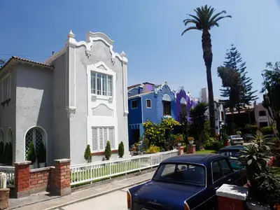 a car parked in front of a blue and white house at Quinta Miraflores Boutique Hotel in Lima