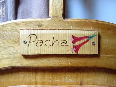 a wooden sign with the word pakistan on it at Picaflor Tambo Guest House in Ollantaytambo