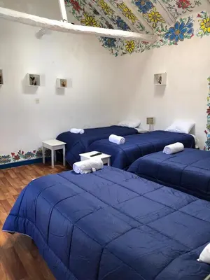 a room with four blue beds in a room at Apartamento Cusco Queswa in Cusco