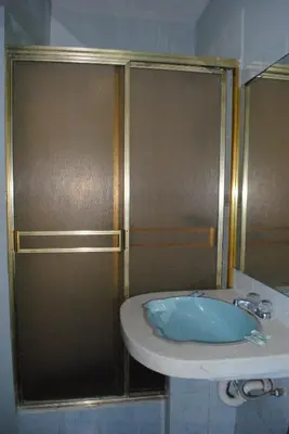 a bathroom with a sink and a shower at Hotel SKY in Lima